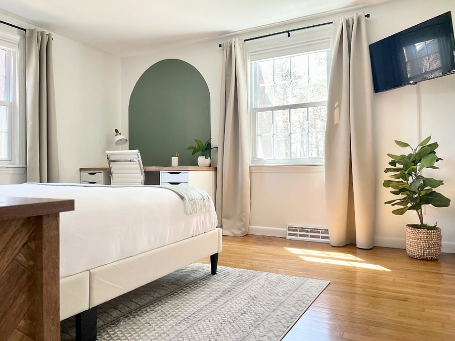 Primary bedroom with workspace and RokuTV