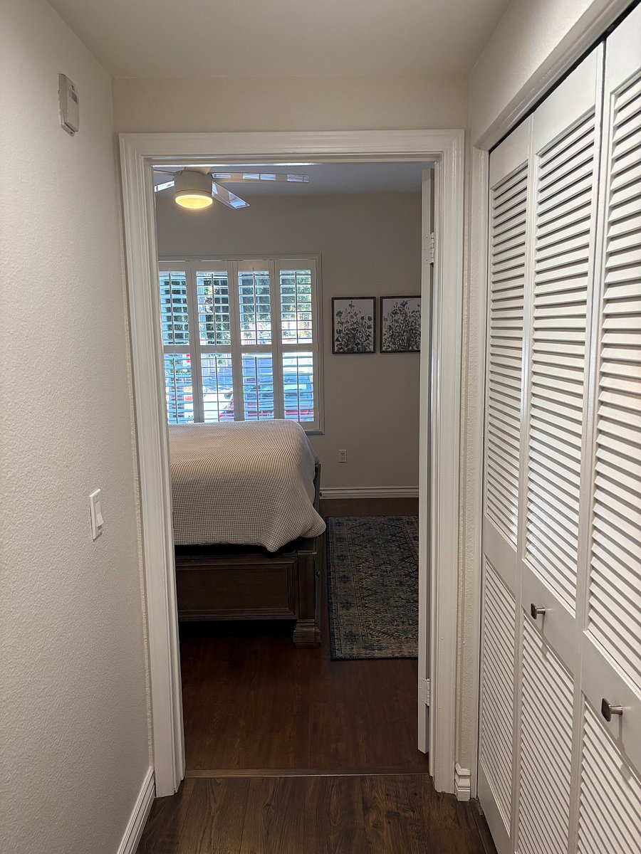 Hallway leading to bedroom. Laundry closet