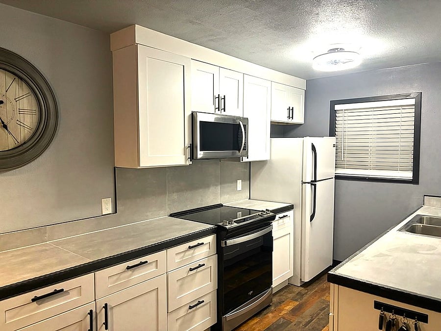A fully upgraded kitchen with lots of cabinets for storage.