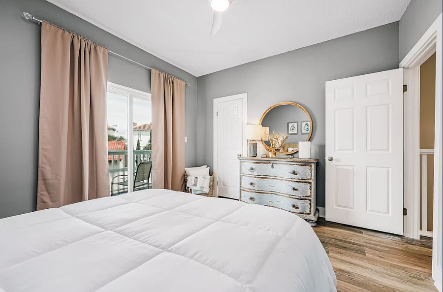 Primary bedroom with king bed, walk in closet and private balcony