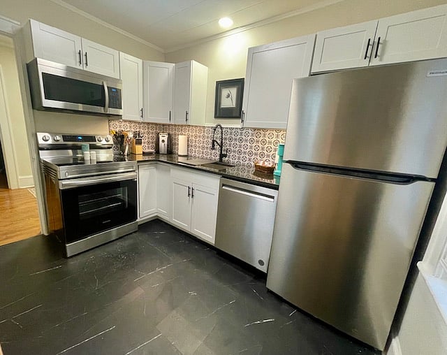 Newly renovated kitchen with SS appliances, granite counters and tile backsplash