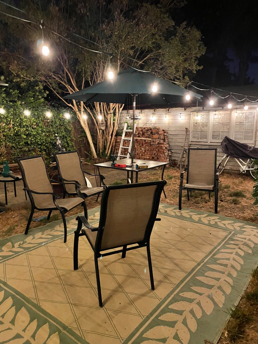 Nicely lit cozy back yard. Not fancy but very tranquil with comfy seating and fire pit by arrangement.