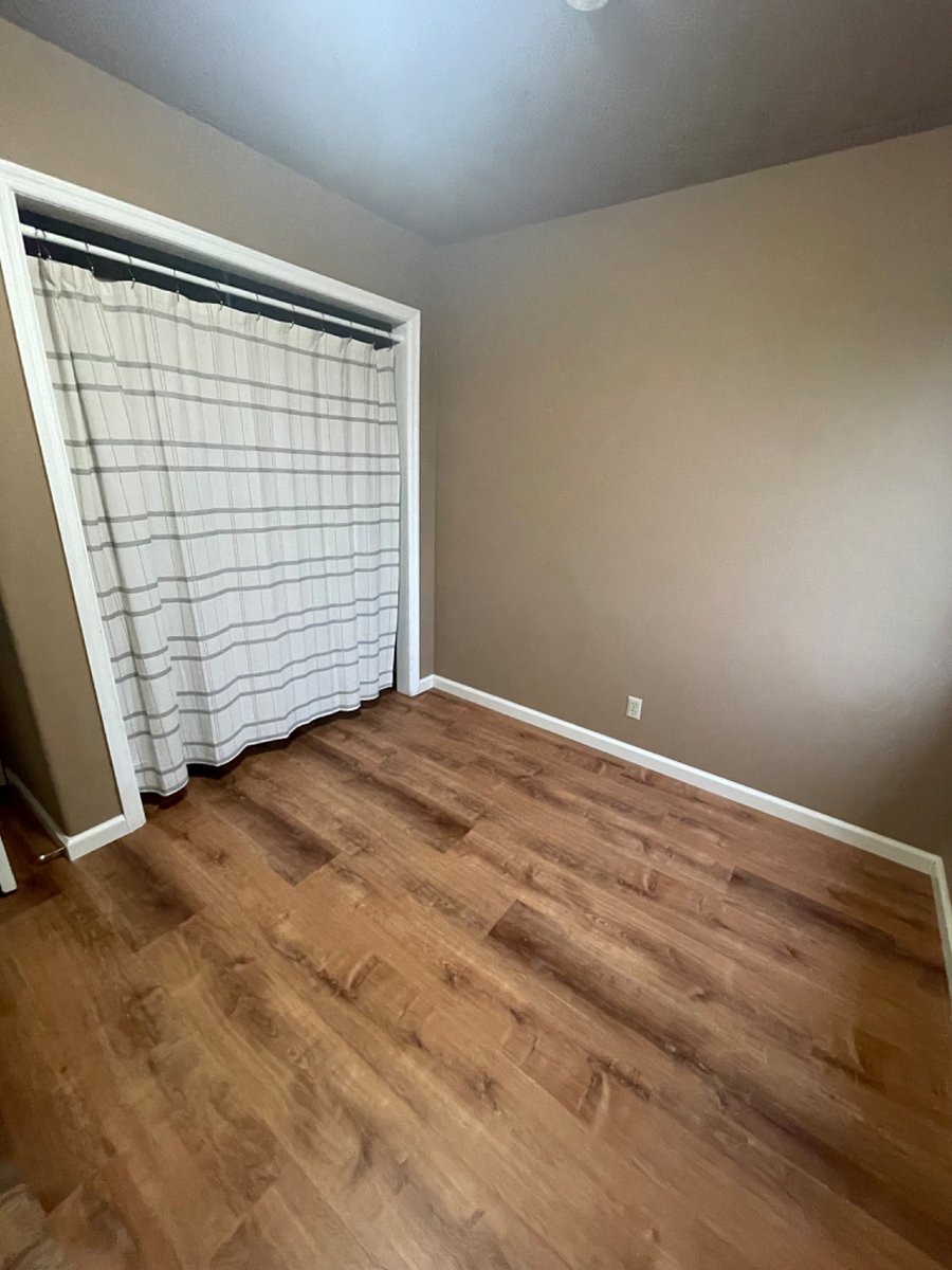 Full size closet with shelving and hanging storage. Curtain closure