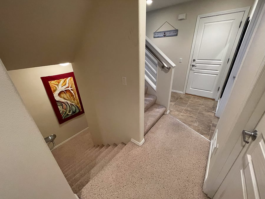 mid-level entrance, leading down to the offered apartment