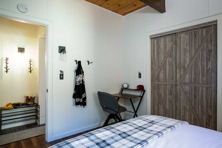 Maine floor bedroom also has a desk, pack and play for kids, floor fan and air conditioning