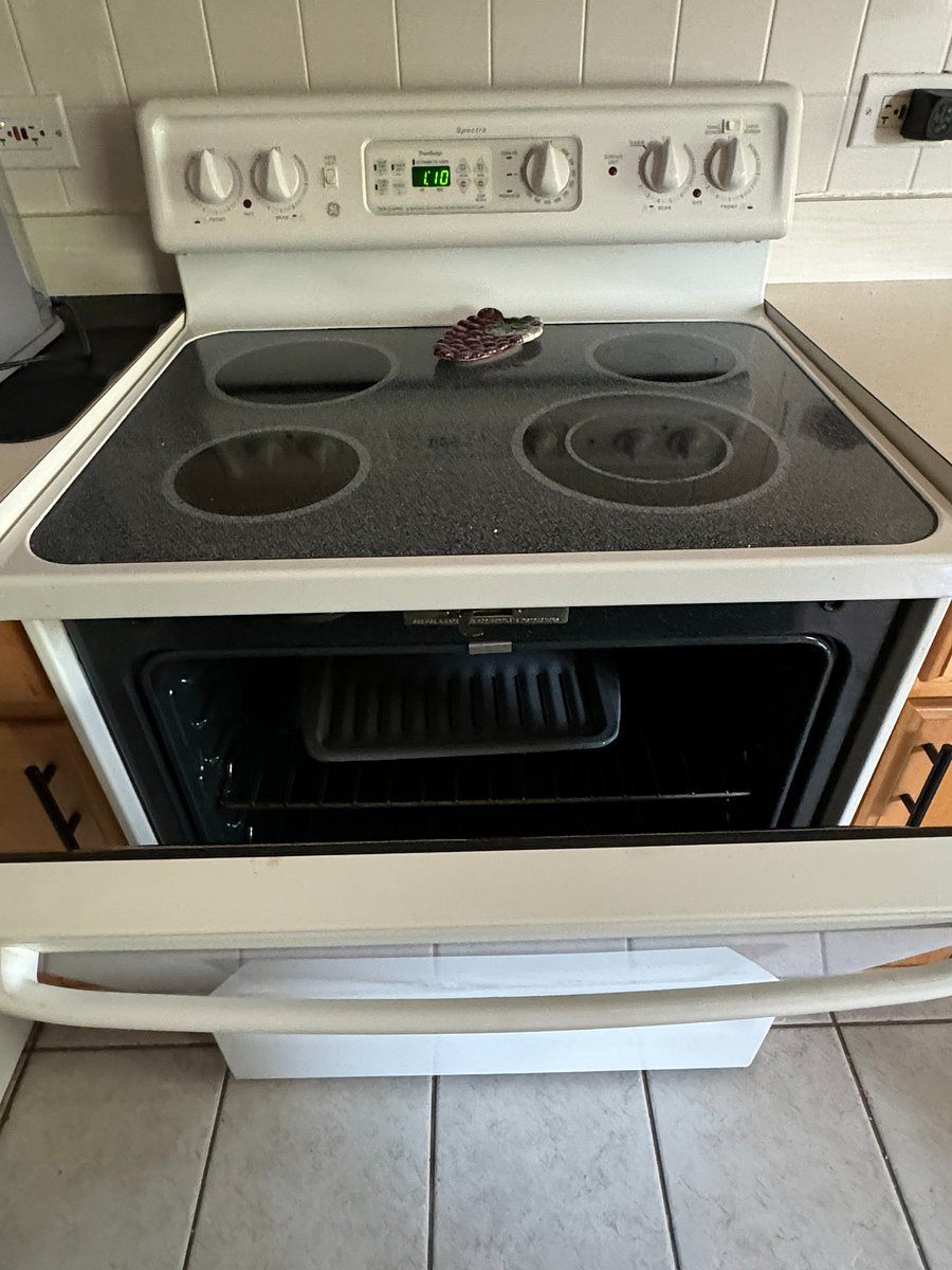 An electric stove is safer and puts fewer particles into the air than a gas stove would.  Nonetheless, please always use the vent when you're cooking.