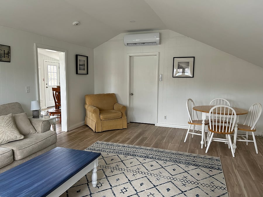 Other side of large living room with door to half bath and laundry