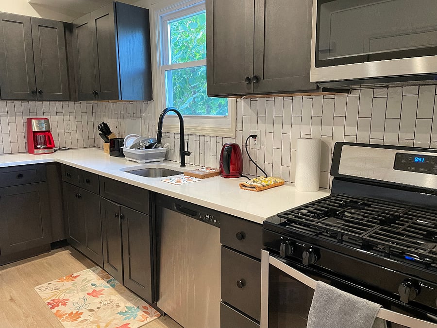 Kitchen with full-size fridge, gas stove, dishwasher, microwave, coffeemaker, toaster, kettle