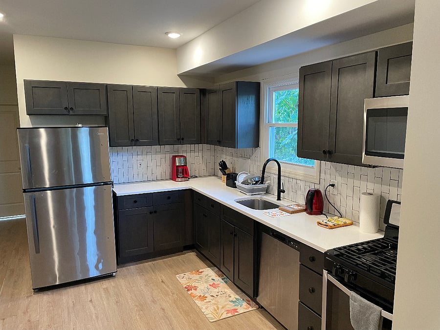 Kitchen with full-size fridge, gas stove, dishwasher, microwave, coffeemaker, toaster, kettle
