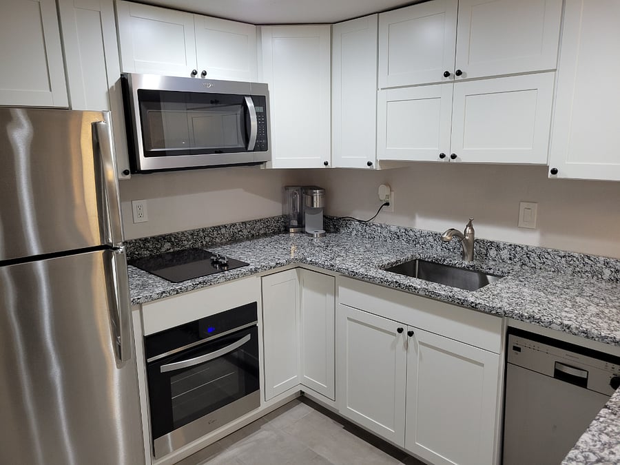 Kitchen with granite countertops and stainless steel appliances 