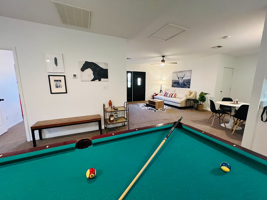 Living space featuring pool table and dining table.