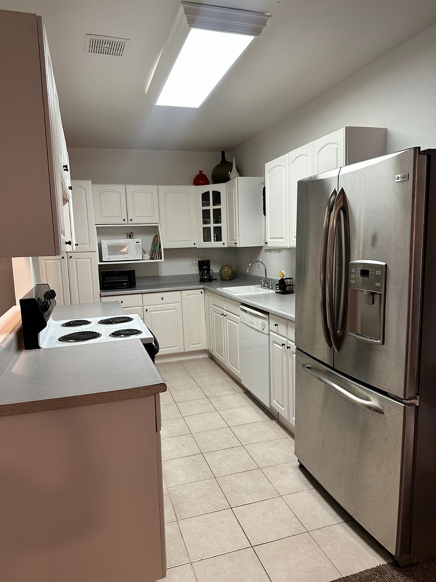 Large kitchen with new French-door refrigerator.