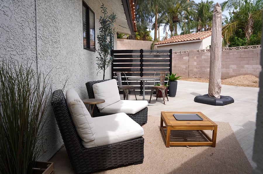 Outdoor seating area with table and chairs.