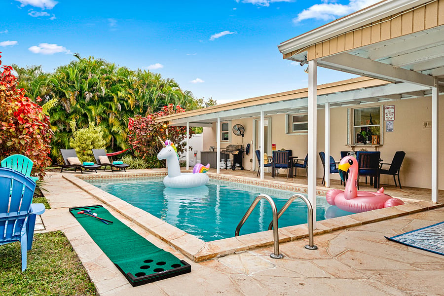 Large back yard with pool and fire pit.