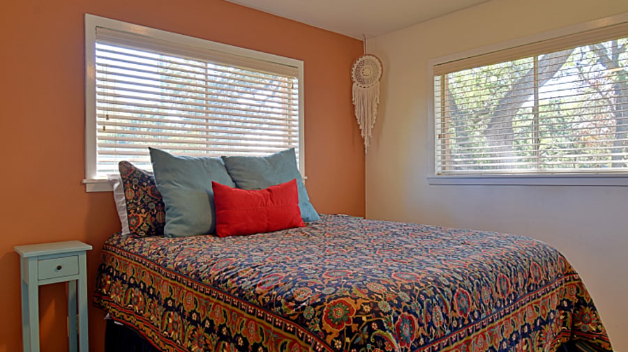 Guest bedroom features a plush queen-sized bed 