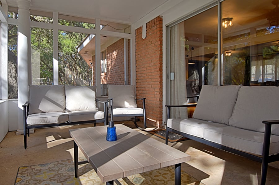 Enjoy the screened-in patio, complete with a comfortable lounging set. Enjoy the fresh air while staying protected from the elementsperfect for morning coffee or evening chats!