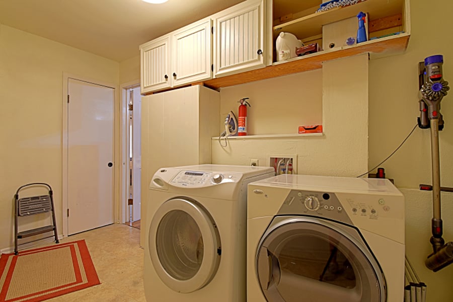 The laundry room is equipped with a free washer and dryer