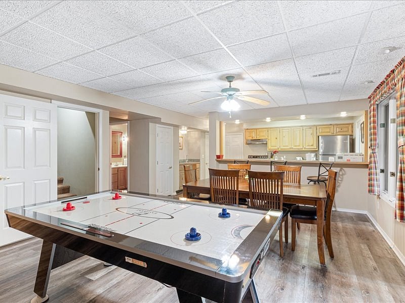 lower level full kitchen, bar, dining table, air hockey table