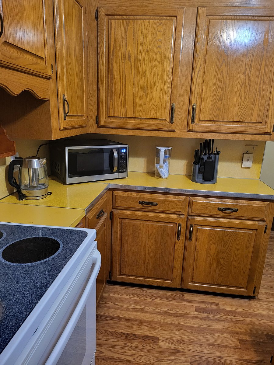 basic kitchen with all appliances including Brita water filter, Ninja coffee maker with K-pod and frother, Electric kettle and microwave. Electric stove partially shown.
