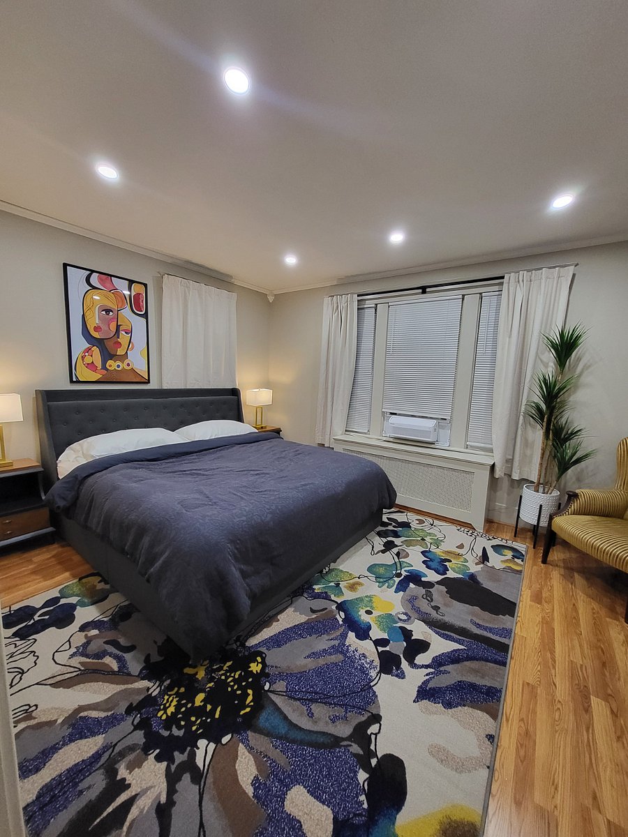 King size bedroom with closets and full length mirror(not shown) and dresser.