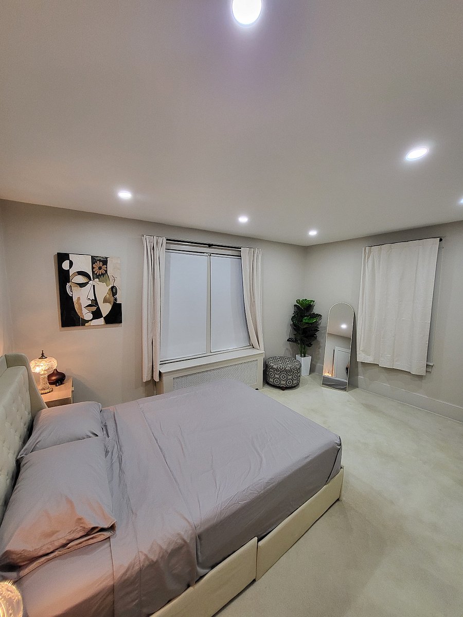 Queen size bed. Full length mirror and storage ottoman. Closet with shelving(not shown)