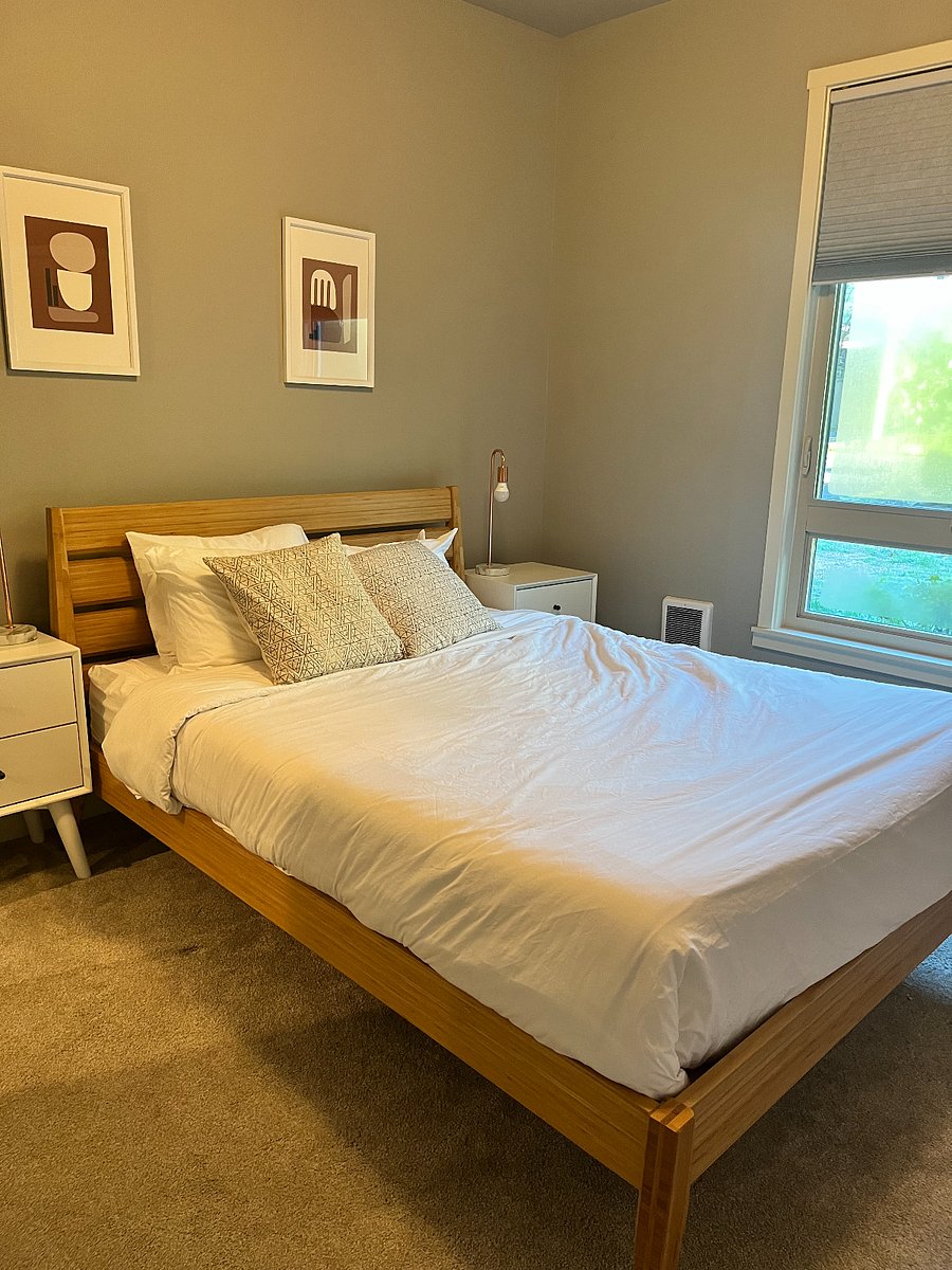 Small bedroom on the main floor with two closets and queen bed.