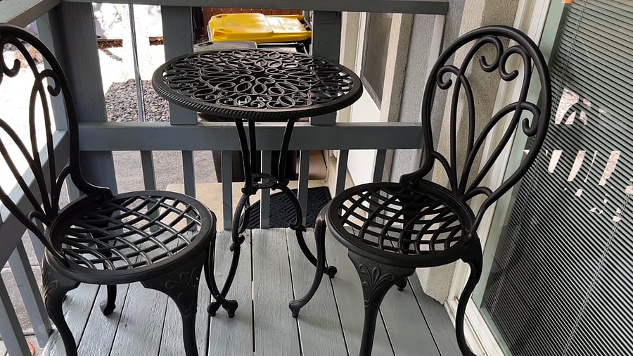 Backyard deck just off the dining area with a bistro set, perfect for morning coffee or fresh air breaks.
