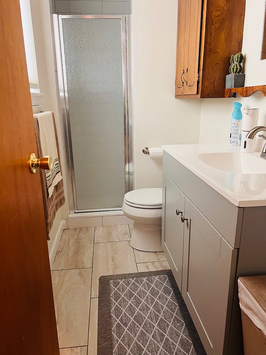3/4 bathroom with natural light and walk-in shower, attached to the garden-level bedroom.
