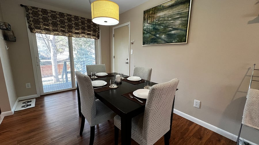 Dining area with seating for four and sliding glass door access to the backyard for easy indoor-outdoor living.
