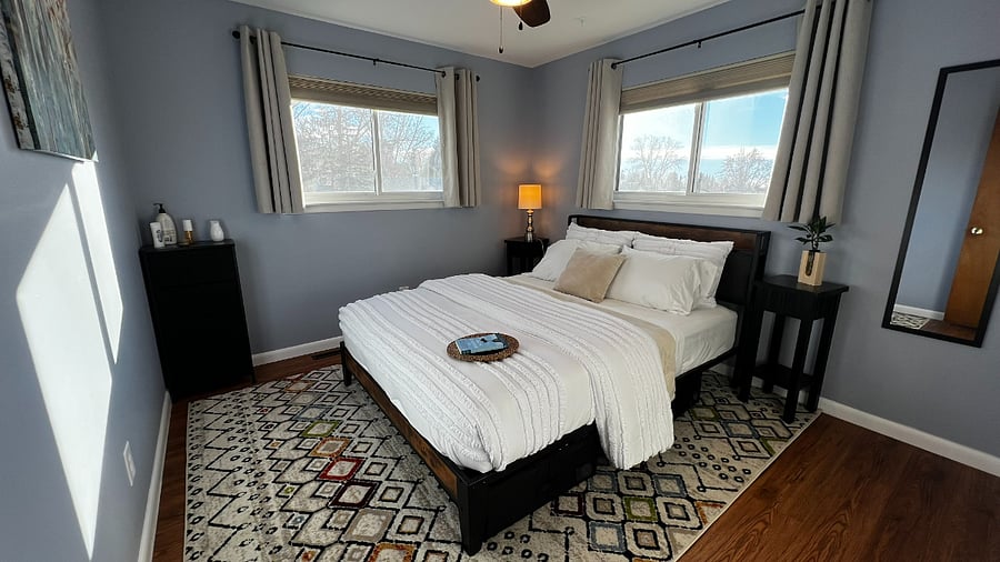 Comfortable queen bedroom with natural light and convenient under-bed storage for extended stays.