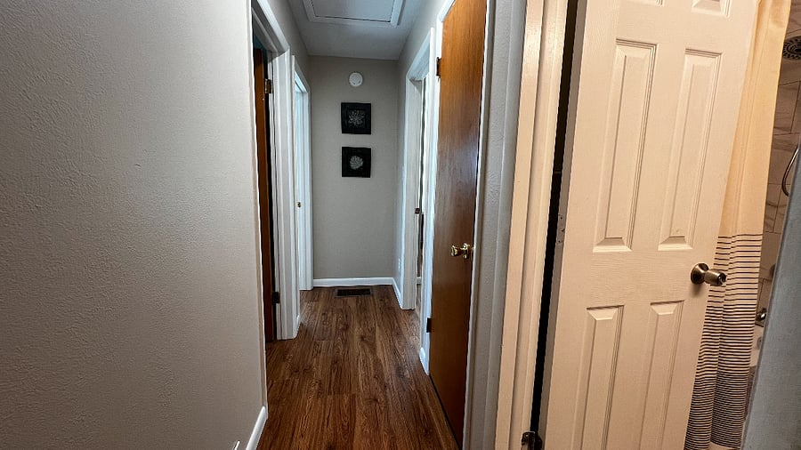 Hallway connecting three bedrooms to the upstairs full bathroom.