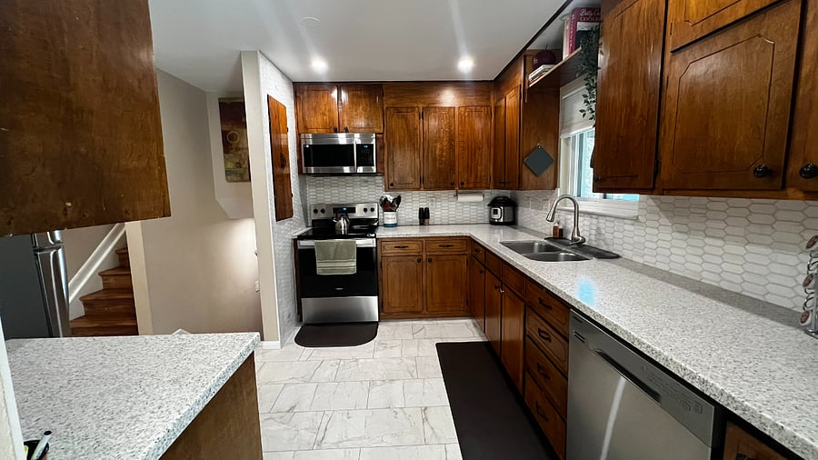 Well-equipped kitchen with modern appliances, full cookware, and a spacious U-shaped layout designed for easy meal prep during extended stays.