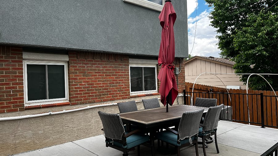 Outdoor patio dining table with seating for six, ideal for meals and gatherings.