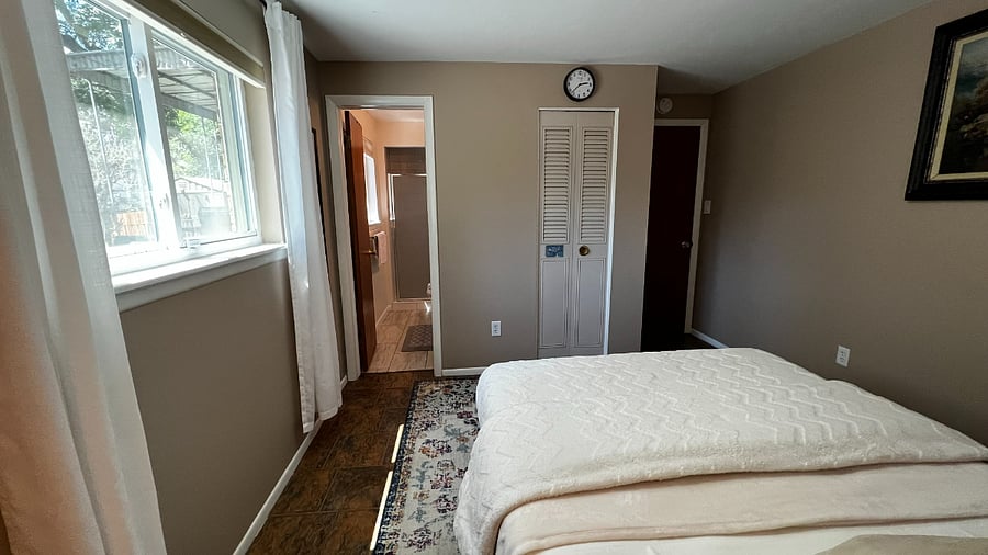 Alternate view of the garden-level bedroom showing the direct path to the attached bathroom.