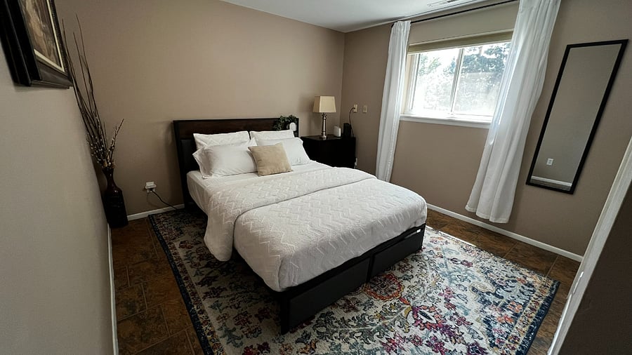 Garden-level bedroom with attached 3/4 bathroom for added privacy and convenience.
