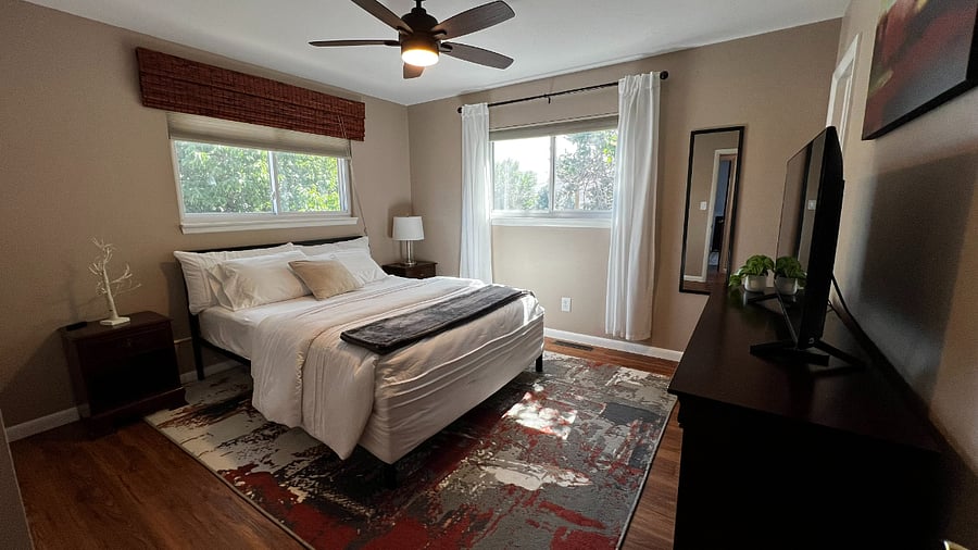 Primary bedroom with a comfortable queen bed and two spacious closets for extended-stay storage.