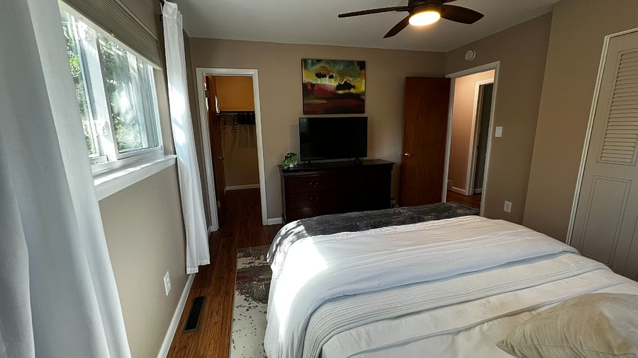 Alternate view of the primary bedroom showing generous closet space and easy access to the hall bathroom.