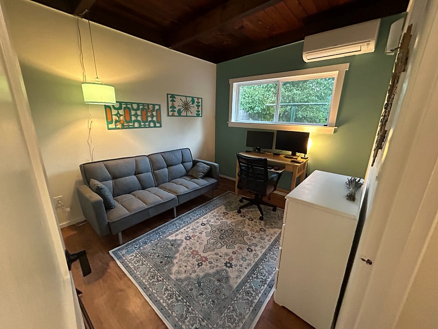 Second bedroom is furnished as an office with a sleeper bed futon, desk with dual monitors, and dresser for additonal storage.