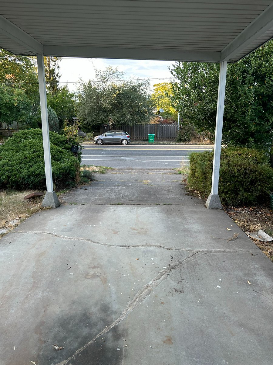 Covered carport at front - driveway is long enough for two vehicles and there is plenty of additional on-street parking.
