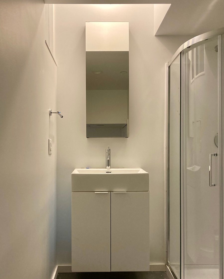 Bathroom with natural light from above. Shower and toilet to the right.