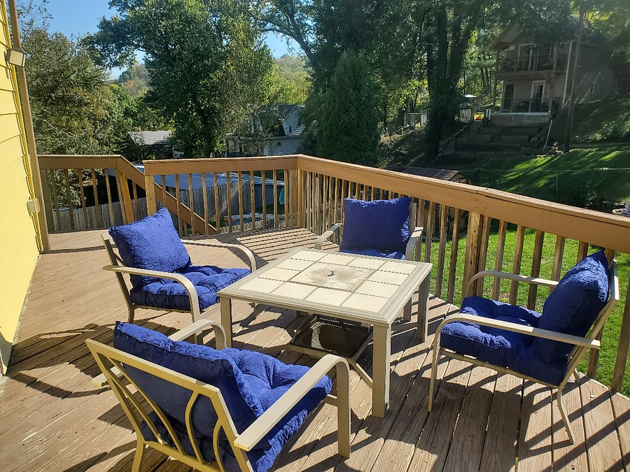 The back deck overlooks a fenced-in back yard and features chairs with memory foam cushions and a small fire pit for cool evenings.