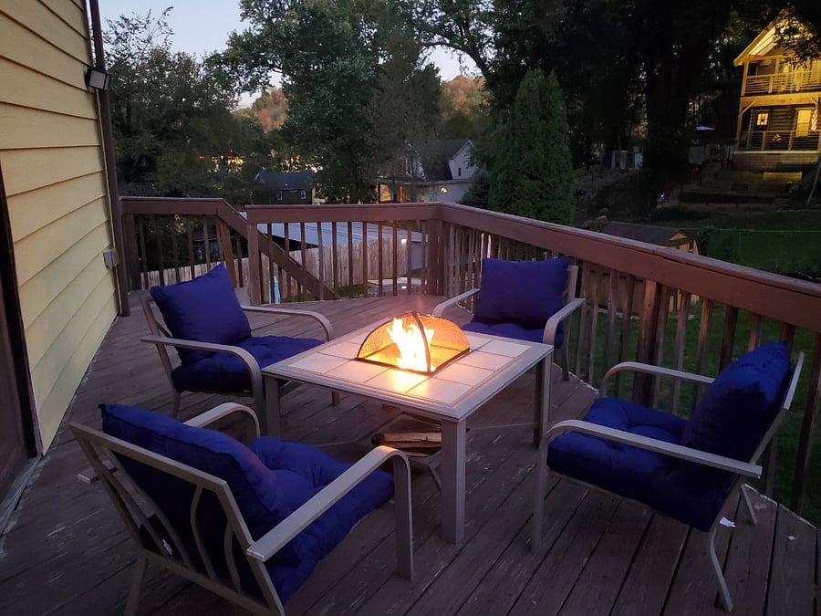 The back deck overlooks a fenced-in back yard and features chairs with memory foam cushions and a small fire pit for cool evenings.