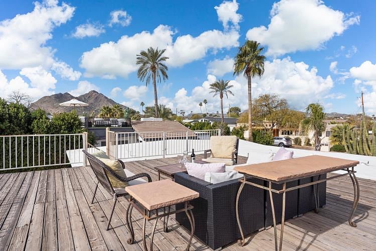 Dining table & sitting area on rooftop deck with incredible views of Camelback Mountain. Lan