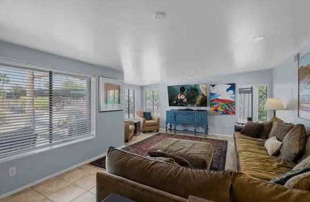 Open floor plan with natural light and oversized couch.