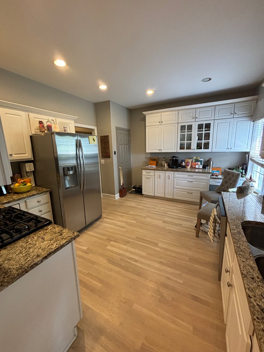 Kitchen with spacious pantry & glass door bar ware cabinet. Plenty of wine glasses, low ball glasses, pots and pans for at home cooking