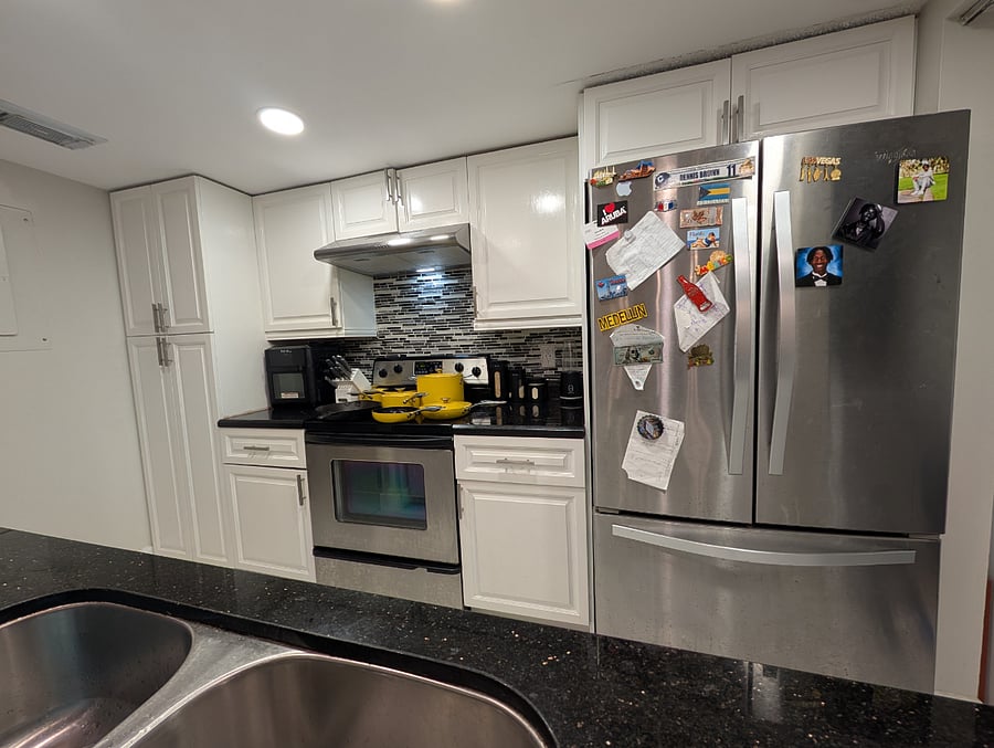 Kitchen stove pots cabinets refrigerator view