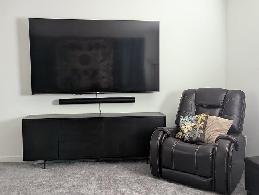 85" smart tv and power recliner in loft
