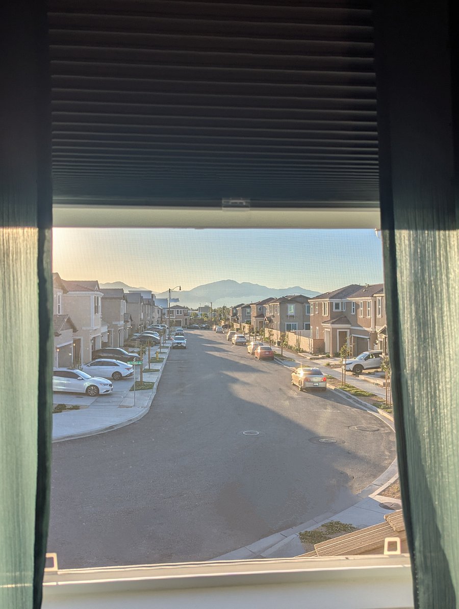 Room #1 Mountain view from bedroom window with screen