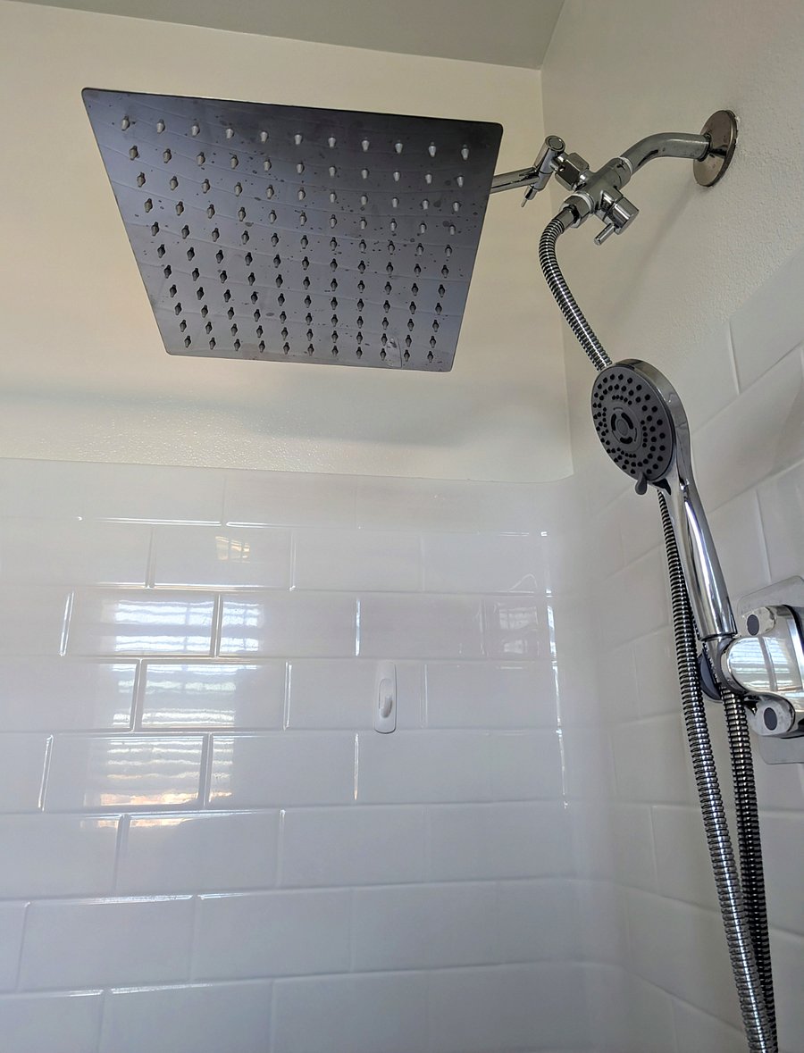 Each restroom has a rain shower head with detachable handheld in private restroom