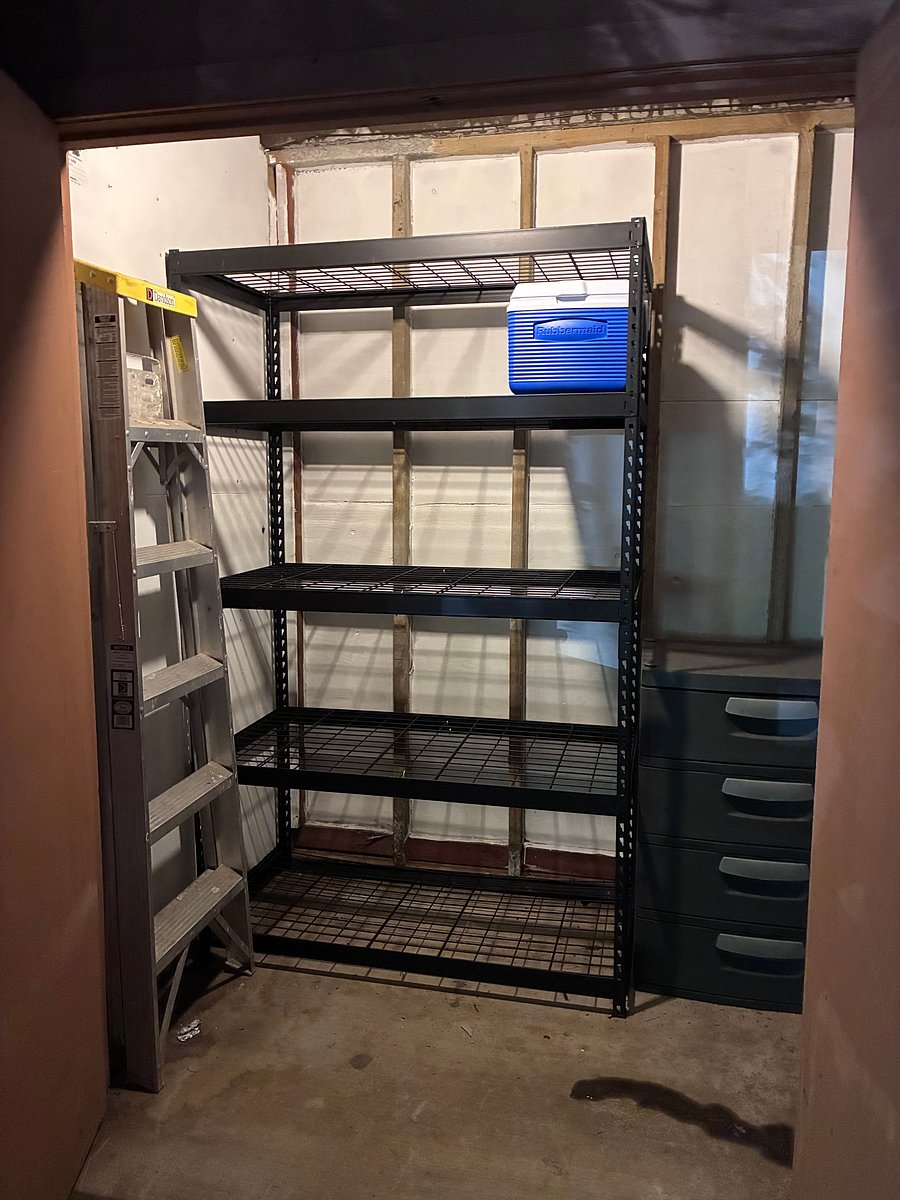 Outdoor, lockable, storage room w/rack and set of plastic drawers. Ladder and ice chest included for your use.